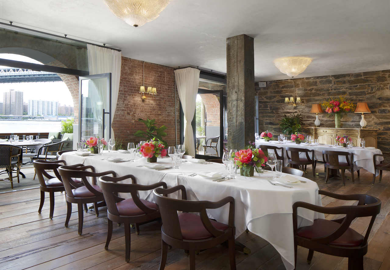 Exposed brick wall dining room with flowers